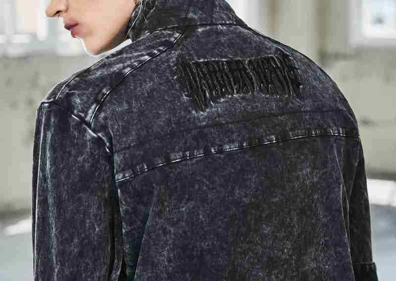 Female model wearing bassline washed denim black zip up jacket - back view