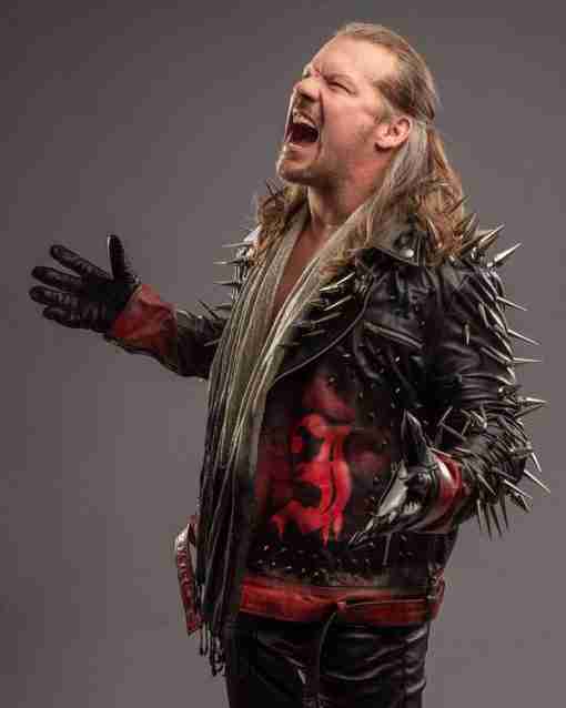 Chris Jericho posing for AEW in his black spiked and studded leather jacket