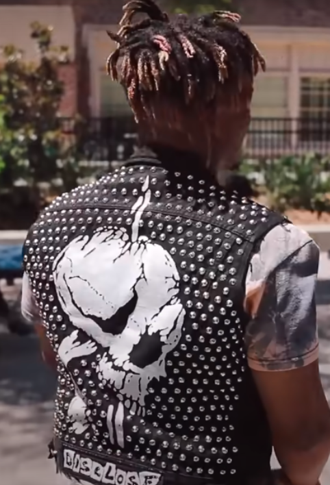 Juice Wrld in a black denim studded vest from the Legends Never Die music video