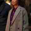 Melanie Liburd in Power Book II: Ghost as Caridad Milgram wearing a grey plaid trench coat