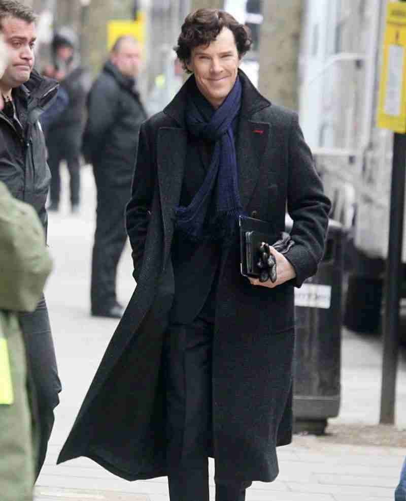 Benedict Cumberbatch on the set of BBC's Sherlock wearing a grayish-black woolen long coat
