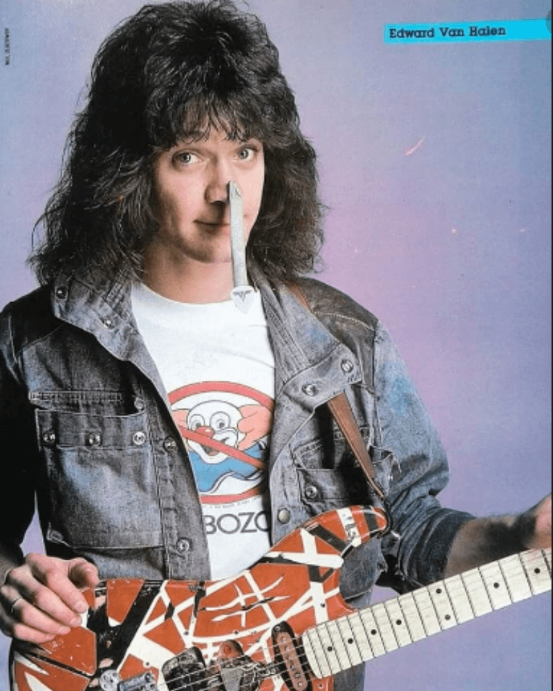 Eddie Van Halen posing in a blue denim jacket