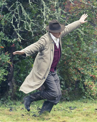 Hugh Bonneville in To Olivia as Roald Dahl in a beige long coat