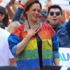 Kamala Harris in a gay pride march wearing a rainbow colored denim jacket