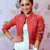 Ariana Grande wearing a red studded cropped leather jacket
