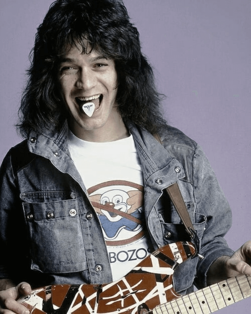 Eddie Van Halen posing for his record in a blue denim jacket