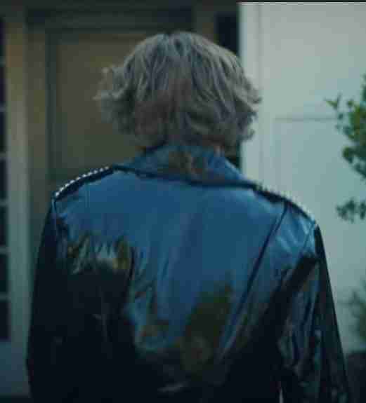 Selfish music video The Kid Laroi wearing a shiny black leather jacket