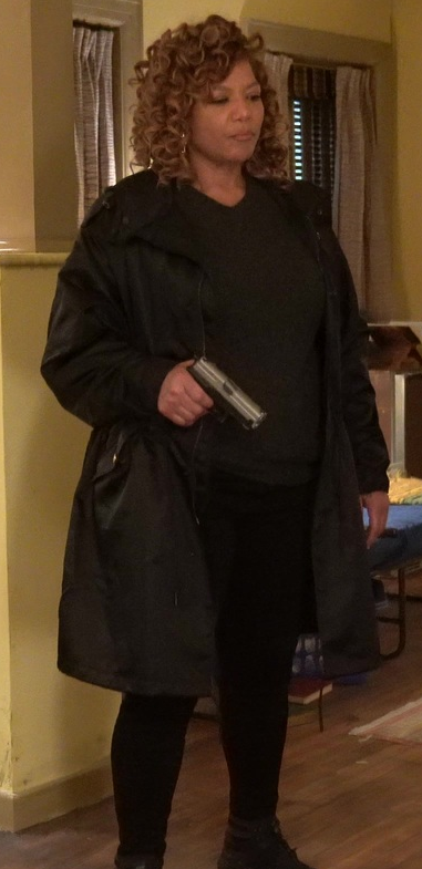 Robyn McCall wearing a long black coat