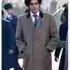 Joel Fry as Jasper from Cruella 2021 movie wearing a mid-length grey coat