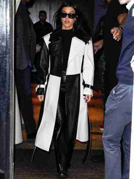 Kourtney Kardashian in a chess design leather trench coat