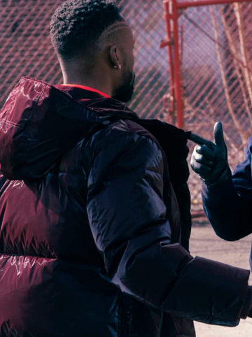 Jayson Wesley as Kenya Bell wearing a maroon puffer jacket in The Equalizer 2021