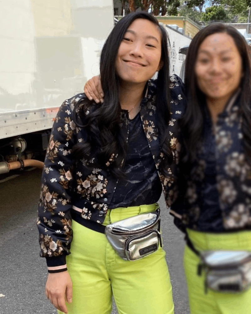 Awkafina on the set of Shang-Chi & the Legend of the Ten Rings wearing a black bomber floral print jacket