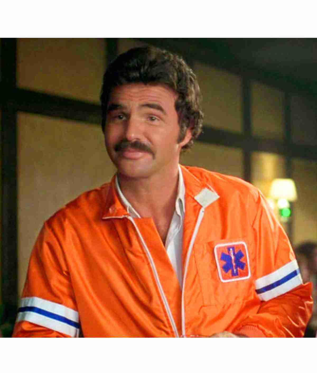 J.J McClure as Burt Reynolds in The Cannonball Run wearing an orange jacket
