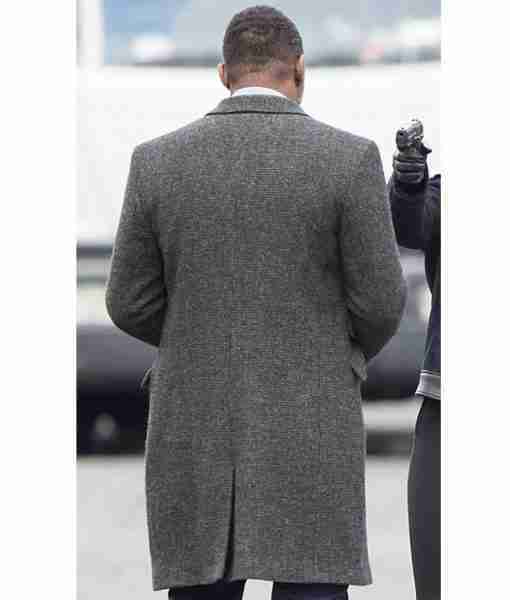 Idris Elba on the set of Luther TV show wearing a grey trench coat