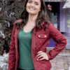 Danica Mckellar as Olivia Arden in You, Me & The Christmas Trees wearing a red quilted jacket