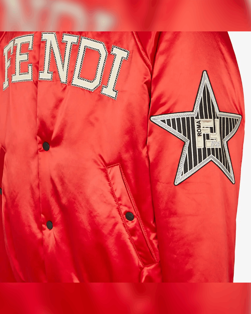 Embroidered patch on the left sleeve of The Kid Laroi's red satin varsity jacket